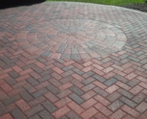 Beautiful brick paver patio rounded in the center and straight on the edges, backyard usable space, brown grays brick paver color