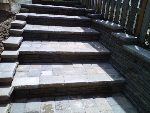 small set of stairs made out of concrete brick pavers. Paver patio, paver patio floor